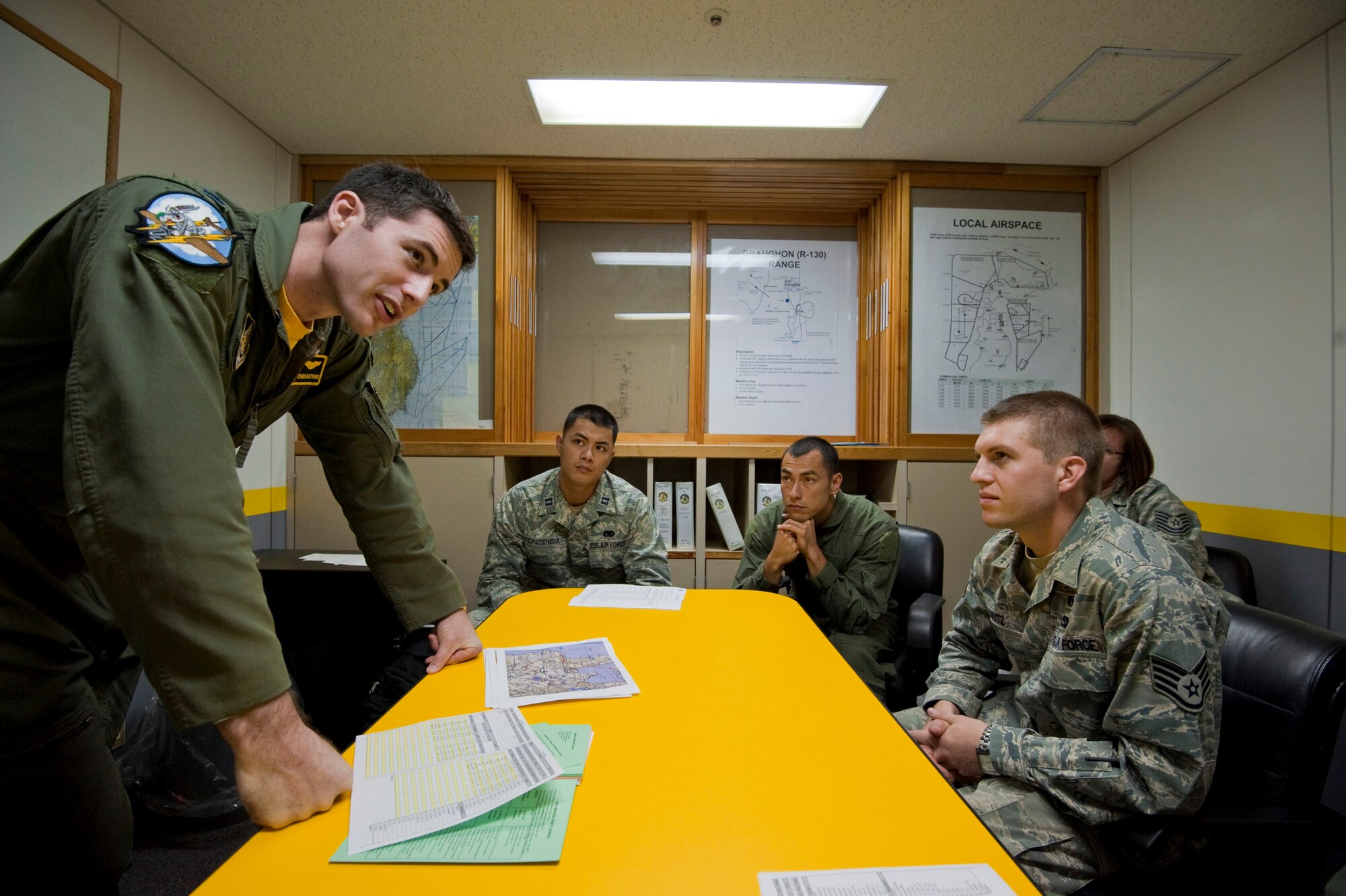 U.S. Air Force Capt. Chris Nations, 14th Fighter Squadron standardization and evaluations officer, gives a mission and safety brief to four incentive fliers at the 14 FS building, Misawa Air Base, Japan, Oct. 22, 2010. The Misawa incentive flight program rewards outstanding Airmen, such as annual award winners, with a backseat ride in an F-16 Fighting Falcon. The 35th Fighter Wing gives incentive flights to outstanding Airmen each year to reward their exceptional work and dedication. (U.S. Air Force photo by Staff Sgt. Samuel Morse/Released)