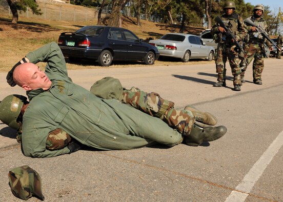 KUNSAN AIR BASE, Republic of Korea -- Staff Sgt. Sergio Griffin, 8th Security Forces Squadron, checks Tech. Sgt. Jeffrey Cornell, enemy force augmentee, after exchanging fire Nov. 2 during exercise Beverly Midnight 10-05. Checking an enemy is important to ensure the enemy is not carrying additional weapons. (U.S. Air Force photo/Senior Airman Ciara Wymbs) 