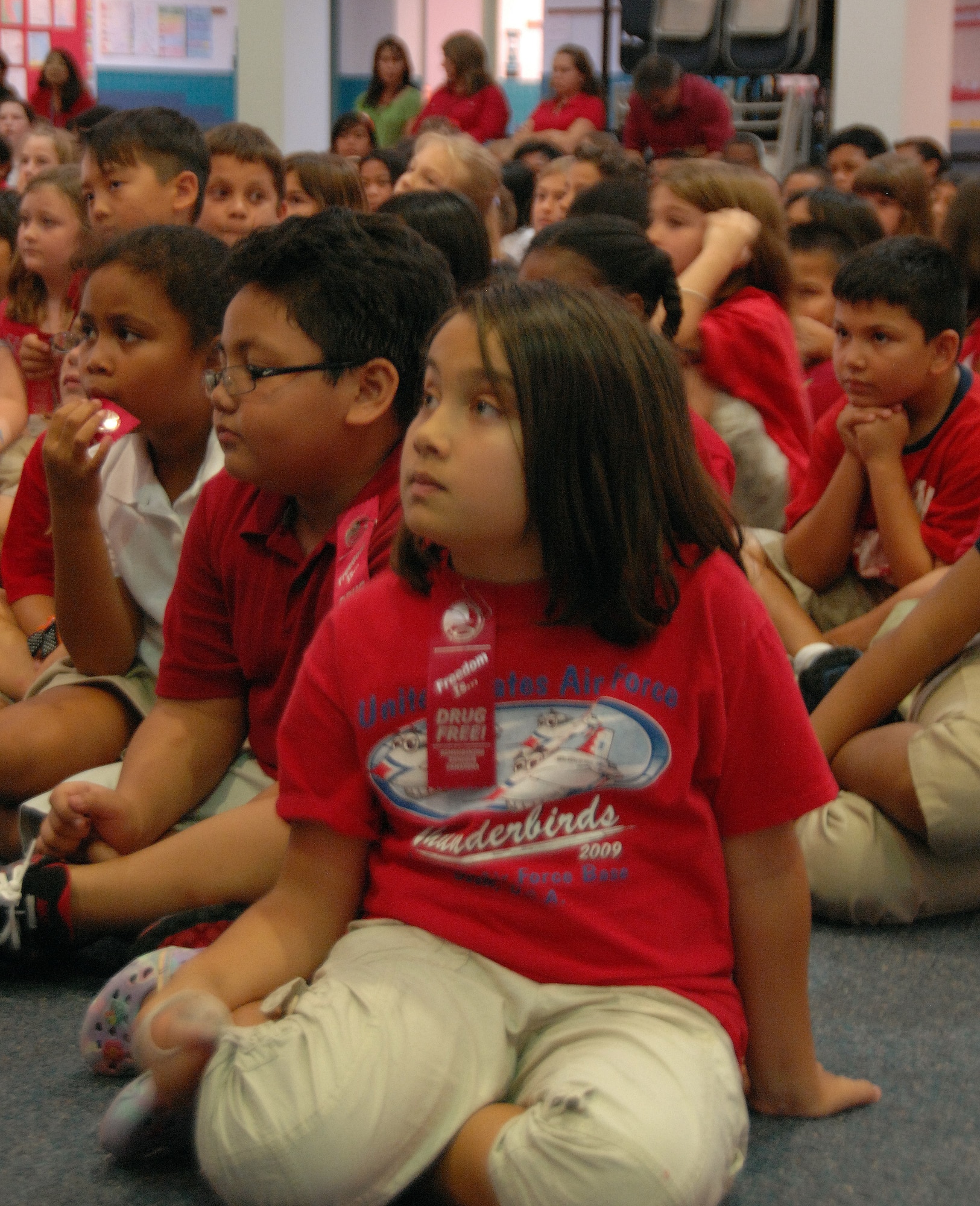 Students at Andersen Elementary attend an assembly on how to lead a healthy and drug-life at AES Oct. 26. Members from the Andersen drug prevention program and Guam Air National Guard speak to children and young adults during the last week of October each year in honor of Red Ribbon Week. (U.S. Air Force photo/Airman Whitney Amstutz)