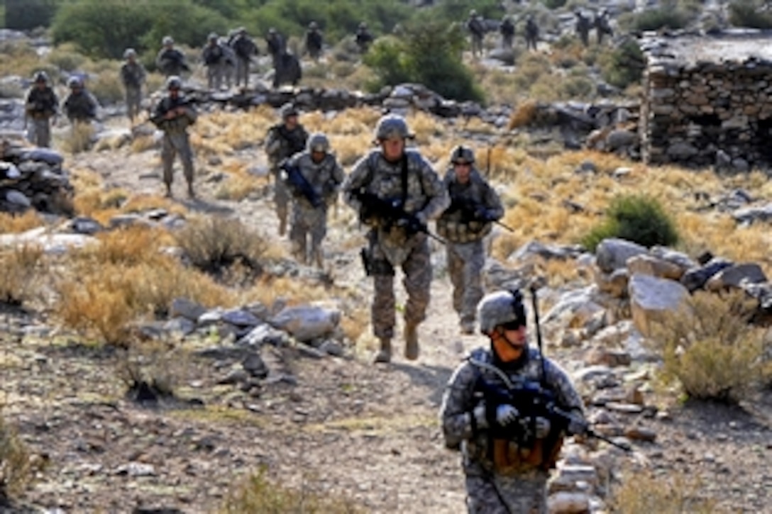 U.S. Army Staff Sgt. James Hatcher, front, leads a column to the village of Kautiak, Nuristan province, Afghanistan, Oct. 30, 2010. Hatcher is assigned to Nuristan Provincial Reconstruction Team, whose members often visit villagers to see how their government is helping them improve their lives after more than three decades of war.