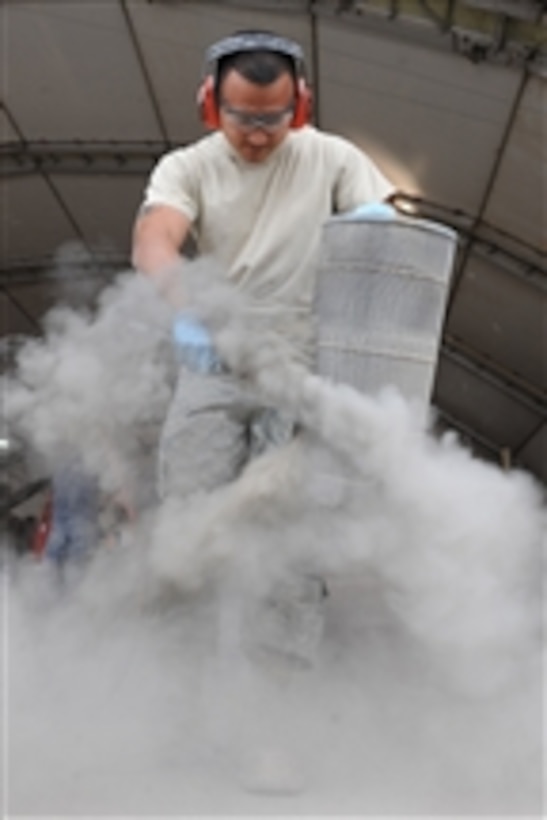 U.S. Air Force Senior Airman Sebero Quintero cleans a vehicle air filter at Kandahar Airfield, Afghanistan, on Oct. 28, 2010.  Quintero is a vehicle maintenance journeyman with the 451st Expeditionary Logistics Squadron.  