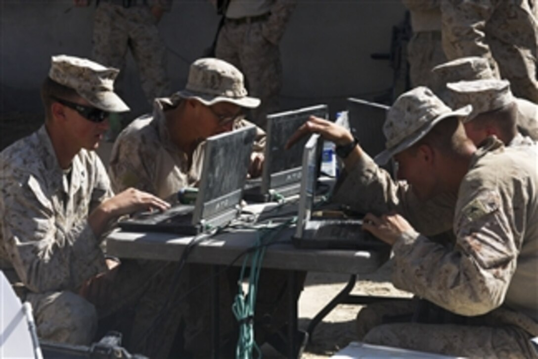 U.S. Marines with Headquarters and Service Company, 3rd Battalion, 5th Marine Regiment, Regimental Combat Team 2, use laptops and telephones at a mobile morale, welfare and recreation center at Forward Operating Base Jackson, Sangin Valley, Afghanistan, on Oct. 5, 2010.  Marines used the electronics to communicate with their families back home.  