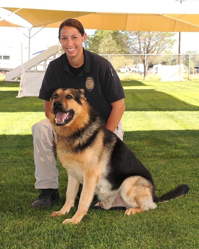 Marine Corps Police Department Officer Terri Piekosz poses for a picture with her working dog Fredi, aboard Marine Corps Logistic Base Barstow, Calif. The 26-year-old Chicago native was informed Aug. 5 that she was accepted to attend Officer Candidate School in Quantico, Va. After serving alongside MCLB Barstow Marines for the past four years, Piekosz will follow her dream of becoming a Marine Corps officer.