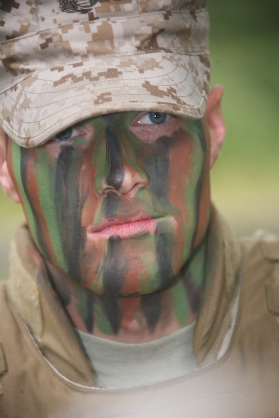 Cpl. Jacob A. Lumbert demonstrates how to apply camouflage paint during the Corporals Leadership Course three-day field operations training exercise at Marine Corps Auxiliary Landing Field Bogue Nov. 3-5.