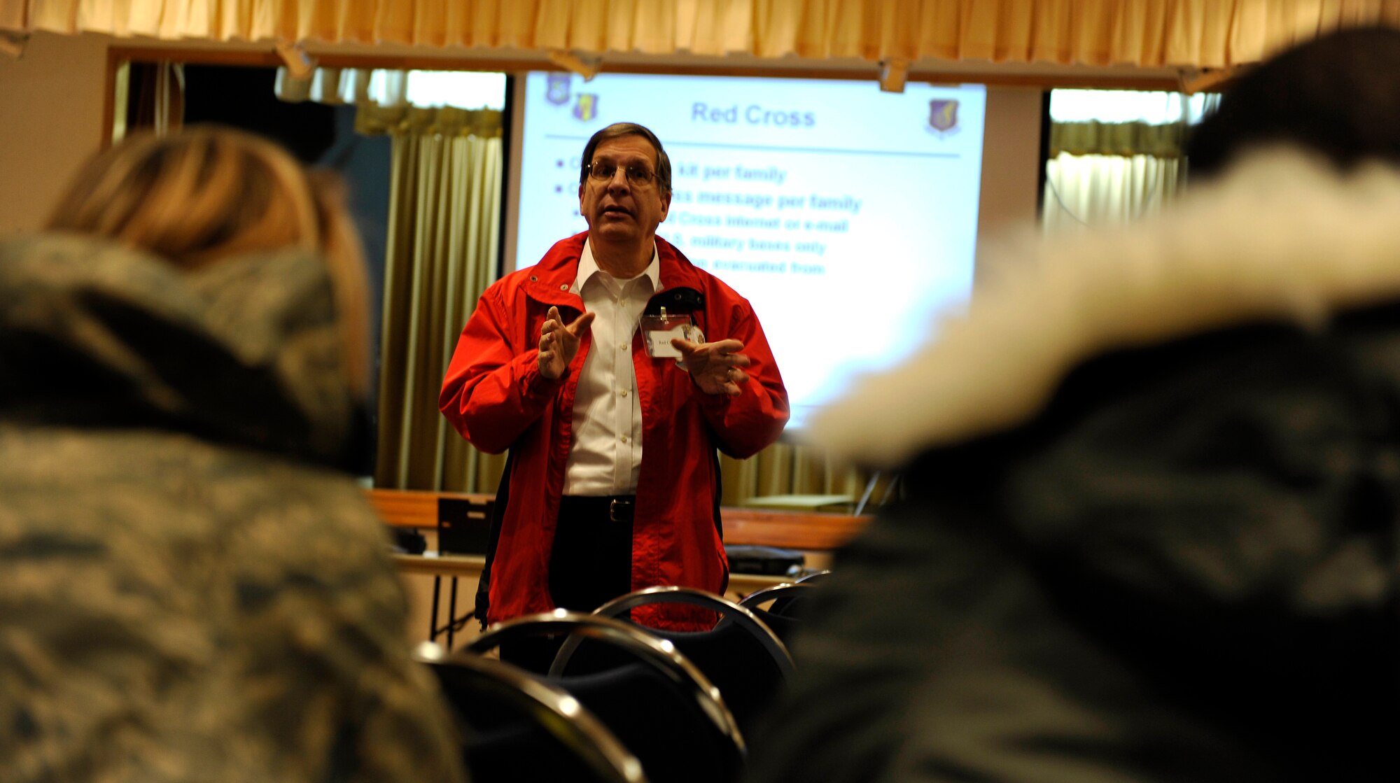 Michael Patton, American Red Cross station manager, briefs simulated evacuees at the Mokuteki Community Center during an operational readiness exercise, Nov. 4, 2010 at Misawa Air Base, Japan. A total of 66 simulated evacuees arrived here following a simulated attack to an allied country.  (U.S. Air Force photo by Staff Sgt. Chad C. Strohmeyer/Released)