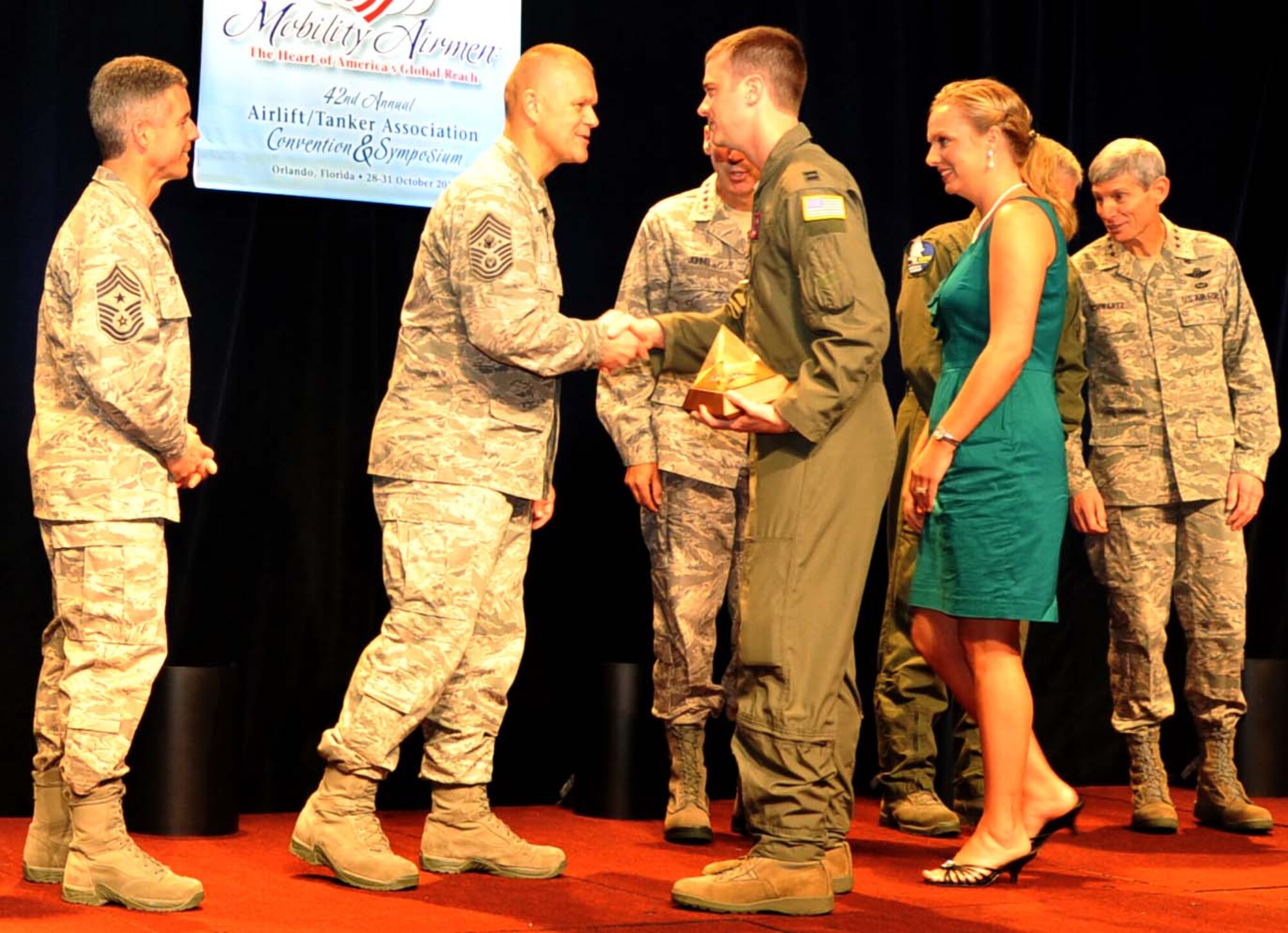 (Center front) Capt. Christopher Macdonald, 349th Air Refueling Squadron instructor pilot and 22nd Maintenance Group executive, shakes hands with Chief Master Sgt. of the Air Force James Roy, after receiving the Gen. Robert “Dutch” Huyser award Oct. 29, 2010, Orlando, Fla.  The award, given by the Airlift/Tanker Association, recognizes individuals who have made outstanding contributions to the airlift/tanker mission.  (U.S. Air Force photo/Senior Airman Abigail Klein)