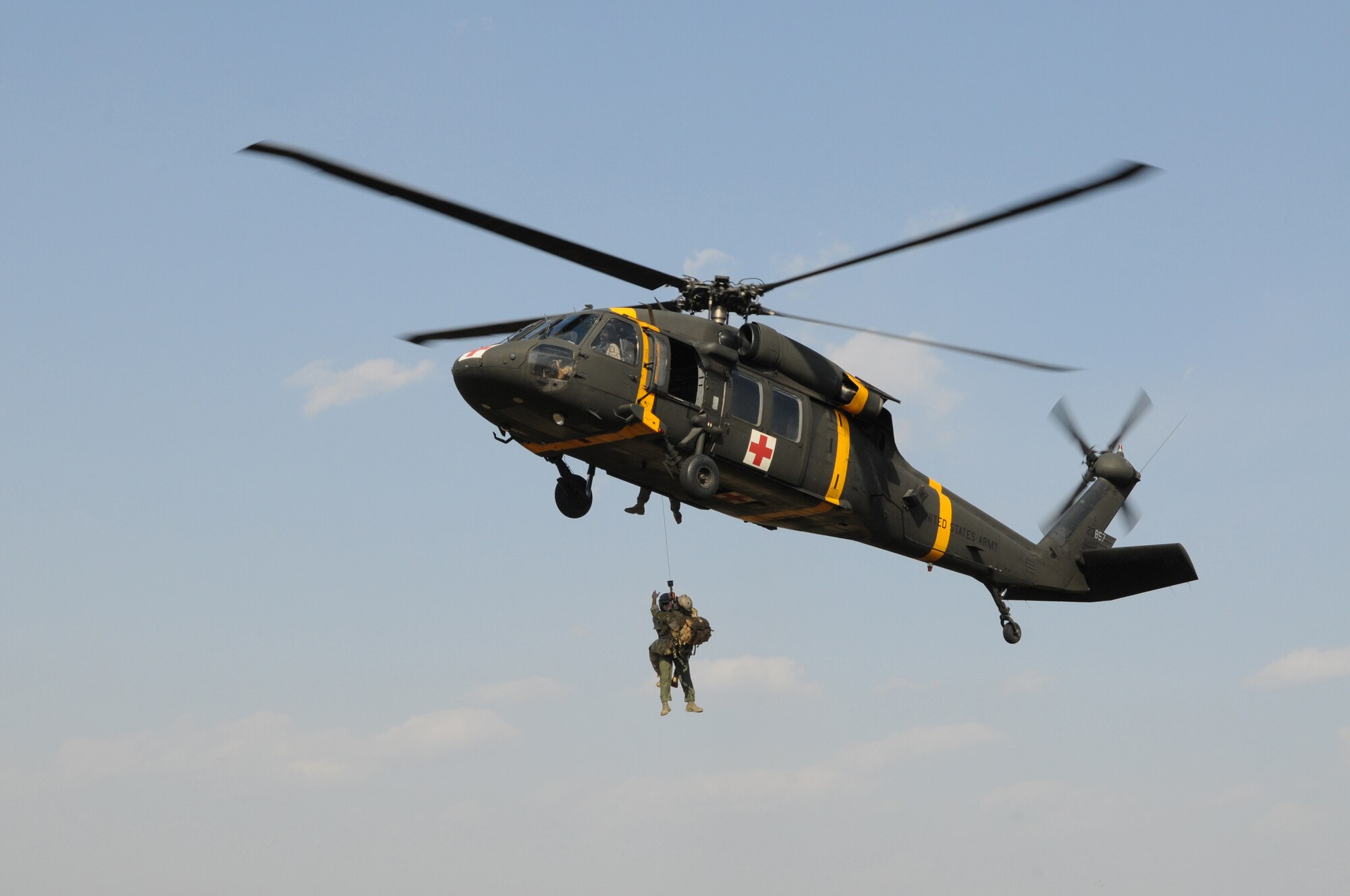 NEAR AN'GANG, Republic of Korea -- Senior Airmen Salvatore Portelli, a pararescueman from the 320th Special Tactics Squadron, and a simulated wounded aircrew member are hoisted into a UH-60 Blackhawk from the 2nd Combat Aviation Brigade from U.S. Army Garrison Humphreys during a combat search and rescue exercise here March 26. The scenario is part of the 353rd Special Operations Group's annual operational readiness exercise. Airman Portelli recently won  the Air Rescue Association 2010 Richard T. Kight Award .The award is named in honor of Brig. Gen. Richard T. Kight, the first commander of the Air Rescue Service, and is presented annually to recognize an active duty or reserve component member who has contributed to the overall effectiveness of the rescue mission area through management, innovation or other outstanding achievement. (U.S. Air Force photo by Tech. Sgt. Aaron Cram)