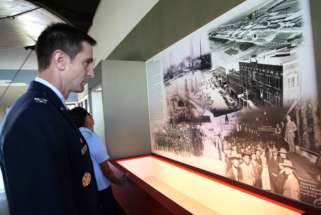 Col. Kevin Schneider, 80th Flying Training Wing commander, looks at an exhibit at the grand opening of the Call Field Aviation Museum, Wichita Falls, Texas, on Oct. 29.  As keynote speaker at the event, the commander bridged the innovative spirit of early aviation with today’s Air Force.  The museum is home to one of five remaining flying Curtiss JN4-D “Jenny” aircraft used during the 1916 – 1918 World War I era.   (U.S. Air Force photo/Debi Smith)