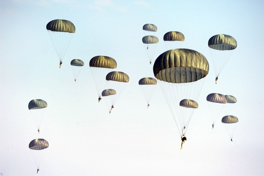 Paratroopers from the 507th Airborne School fall from the sky over Fort Benning, Ga., Oct. 14, 2010, after jumping out of a C-17 Globemaster III from the 535th Airlift Squadron at Joint Base Pearl Harbor-Hickam, Hawaii. A C-17 aircrew from the 15th Wing flew from Hawaii to Fort Benning to support the student jump requirements of the 507th AS. (U.S. Air Force photo/Staff Sgt. Nathan Allen) 
