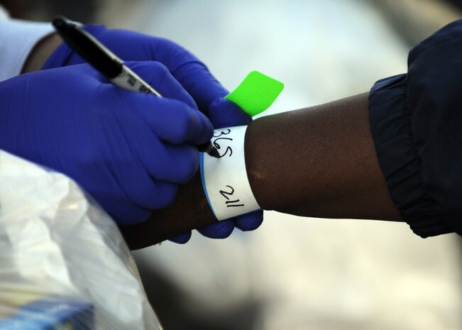 Master Sgt. Anthony Mullins assigns a number to a homeless veteran to later identify the individual as the owner of a bag left at the bag storage area at the 11th annual Stand Down Against Homelessness Oct. 29, 2010, at the North Charleston Armory Park, S.C. Sponsored by the Ralph H. Johnson Veterans Affairs Medical Center and Goodwill Industries, the event provided food, clothing vouchers, medical and dental screenings, job and legal assistance and personal hygiene items to the homeless. (U.S. Air Force photo/Senior Airman Timothy Taylor)
