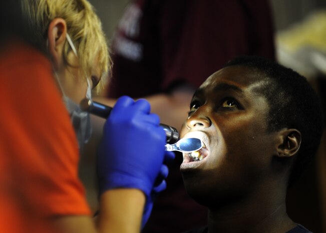 Tyler Williams performs a dental checkup for a homeless woman at the 11th annual Stand Down Against Homelessness Oct. 29, 2010, at the North Charleston Armory Park, S.C. Mr. Williams is a dentist with Veterans Affairs who volunteered for this event. (U.S. Air Force photo/Senior Airman Timothy Taylor)
