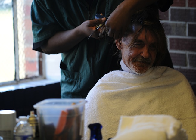 Mr. Tony Skinner gets his hair trimmed by a volunteer barber at the 11th annual Stand Down Against Homelessness Oct. 29, 2010, at the North Charleston Armory Park, S.C. More than 2,068 homeless veterans and civilians received services like haircuts to help get them back on their feet and raise morale in the process. Mr. Skinner is a veteran for the United States Army. (U.S. Air Force photo/Senior Airman Timothy Taylor)
