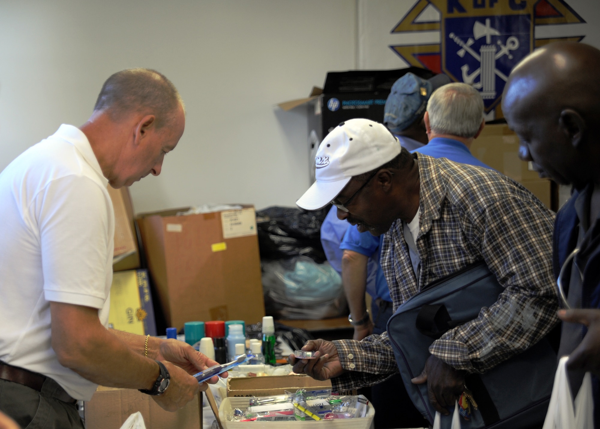 Members from The Knights of Columbus, Council 6250, pass out hygiene products to homeless veterans and civilians at the 11th annual Stand Down Against Homelessness Oct. 29, 2010, at the North Charleston Armory Park, S.C. The Knights of Columbus is the world's largest Catholic fraternal service organization. There are more than 1.8 million members in 15,000 councils, with nearly 200 councils on college campuses. (U.S. Air Force photo/Senior Airman Timothy Taylor)


