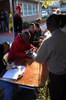 Volunteers process veterans and civilians before entering the 'Stand Down' facility for dental and medical checkups, at the 11th annual Stand Down Against Homelessness Oct. 29, 2010, at the North Charleston Armory Park, S.C. Sponsored by the Ralph H. Johnson Veterans Affairs Medical Center and Goodwill Industries, the event provided food, clothing vouchers, medical and dental screenings, job and legal assistance, and personal hygiene items to the homeless. (U.S. Air Force photo/Senior Airman Timothy Taylor)