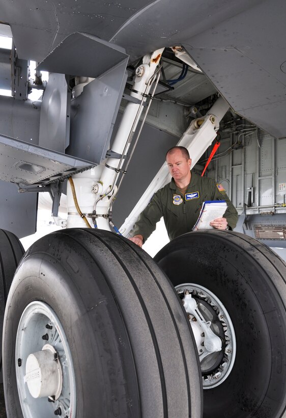 Maj. Rob Walmsley, 912th Air Refueling Squadron operations officer, demonstrates a KC-135 Globemaster III pre-flight check at March Air Reserve Base, Calif. , Oct. 21, 2010. The 912th Air Refueling Squadron stood up Oct. 1, 2010 as an active duty associate unit with the 336th Air Refueling Squadron at March. 