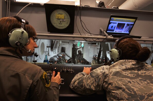 SHAW AIR FORCE BASE, S.C. -- Senior Airman Kelsey Buchholz, 20th Aerospace Medicine Squadron aerospace and operational physiologist technician, controls the altitude while Senior Airman Jeylyn Capdevilla, 20th Aerospace Medicine Squadron aerospace and operational physiologist technician, instructs students at the aerospace physiology building Nov. 2, 2010. The high altitude parachute class focuses on human performance at high altitudes and high stress levels. Students take this class before freefall school and as a refresher course every five years. (U.S. Air Force photo/Airman 1st Class Tabatha L. Duarte