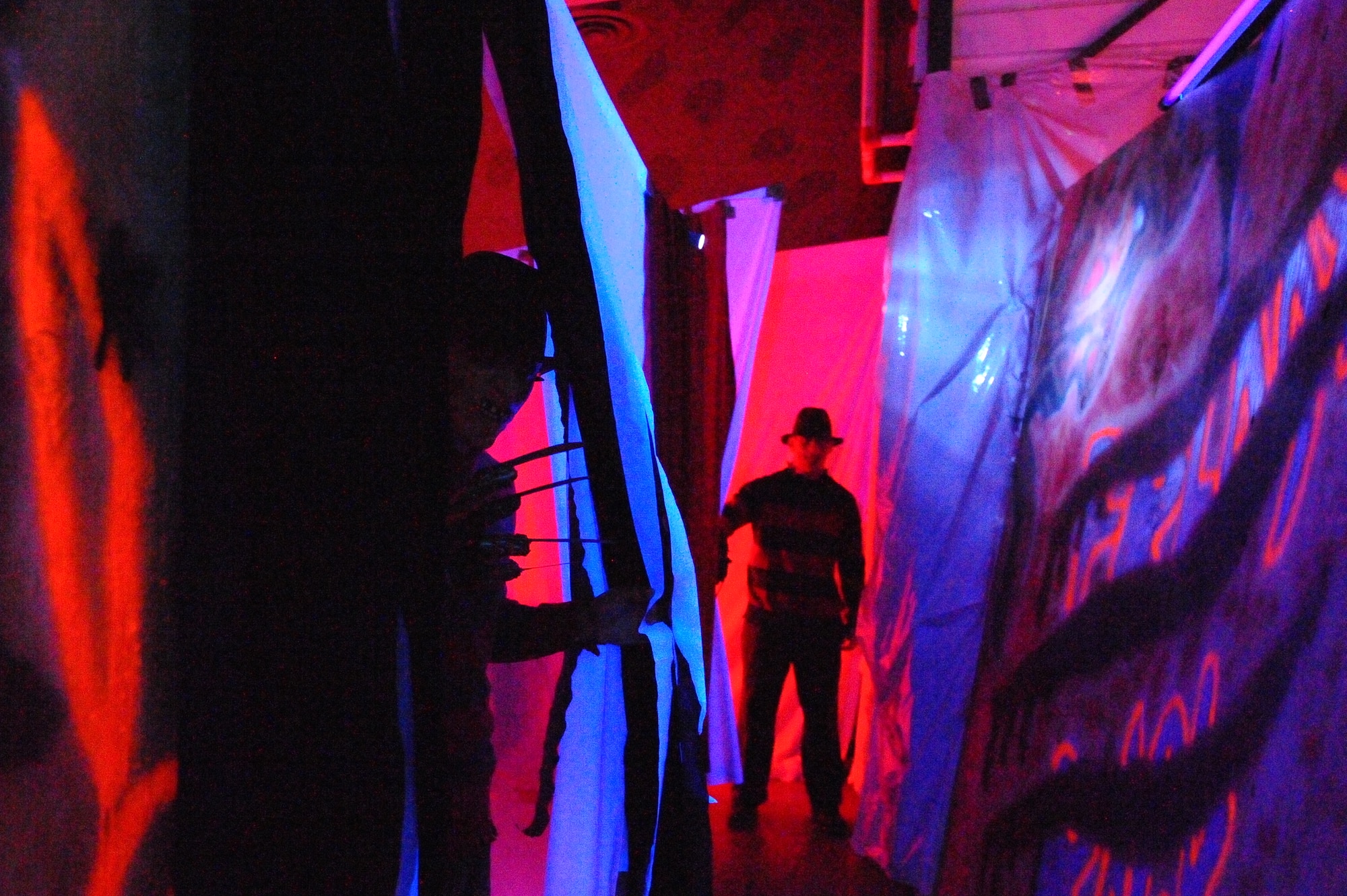 MINOT AIR FORCE BASE, N.D. -- Multiple Freddy Kruegers lie in wait to terrorize victims as they walk through “Elm Street” inside the  5th Force Support Squadron haunted house inside the Minot Outdoor Recreation facility here Oct. 29. Events like these keep Airmen and family morale and spirits high as cold and snow become a mainstay for Team Minot. (U.S. Air Force photo by Master Sgt. Michael Gaddis)