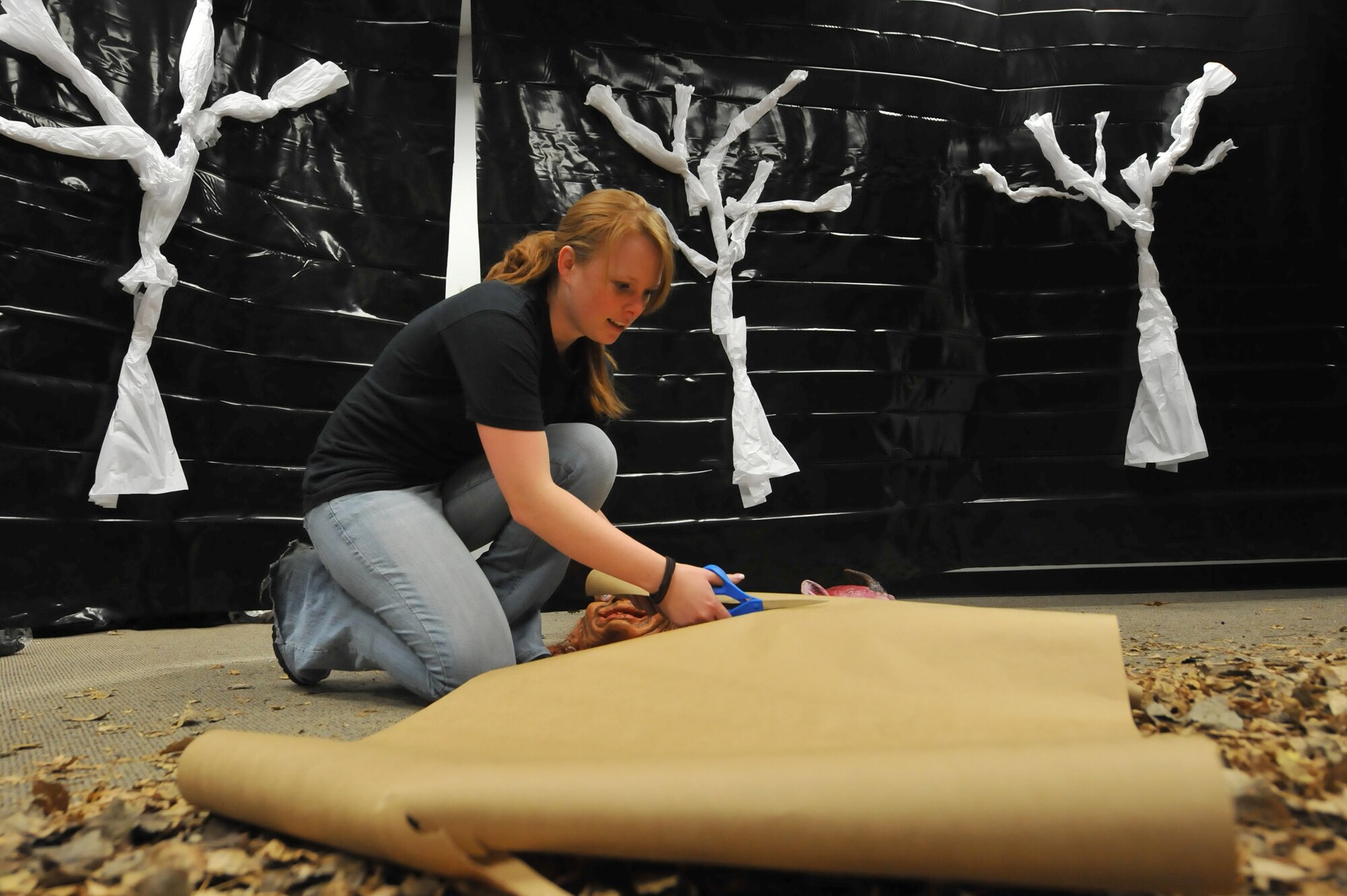 MINOT AIR FORCE BASE, N.D. -- Senior Airman Natasha Ashley, 742nd Missile Squadron missile chef, works on decorations to finalize of her part of the 5th Force Support Squadron haunted house. Airman Ashley and numerous other volunteers made the haunted house inside the Minot Outdoor Recreation facility a success here Oct. 29. Events like these keep Airmen and family morale and spirits high as cold and snow become a mainstay for Team Minot. (U.S. Air Force photo by Master Sgt. Michael Gaddis)