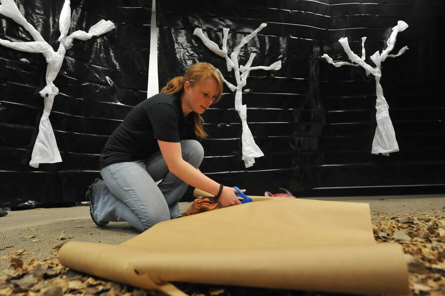 MINOT AIR FORCE BASE, N.D. -- Senior Airman Natasha Ashley, 742nd Missile Squadron missile chef, works on decorations to finalize of her part of the 5th Force Support Squadron haunted house. Airman Ashley and numerous other volunteers made the haunted house inside the Minot Outdoor Recreation facility a success here Oct. 29. Events like these keep Airmen and family morale and spirits high as cold and snow become a mainstay for Team Minot. (U.S. Air Force photo by Master Sgt. Michael Gaddis)