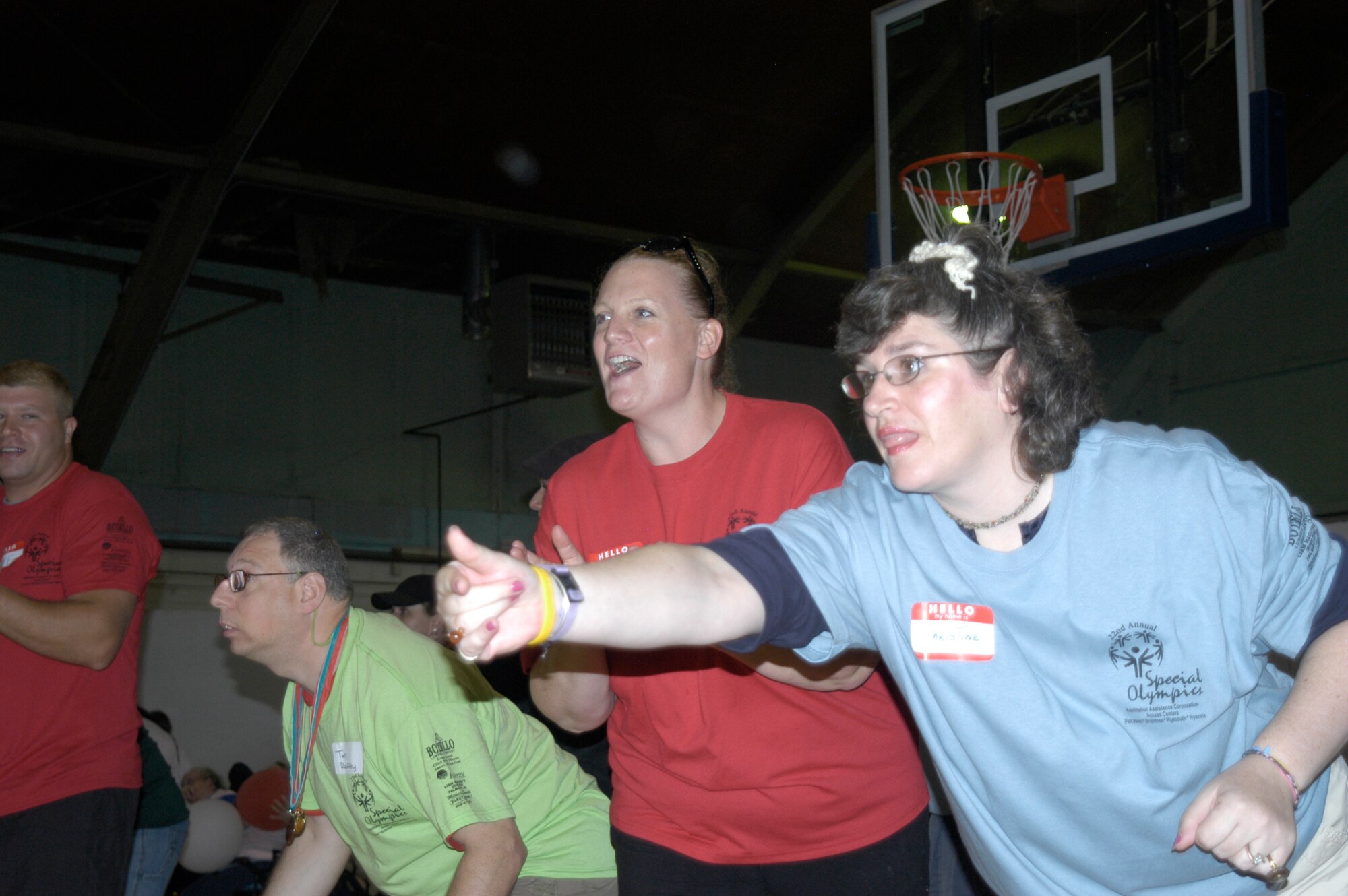 Technical Sgt. Victoria Kenny (second from right), 102nd Logistics Readiness Squadron, cheers on Special Olympians during a relay race at the 22nd annual Southeastern Massachusetts Special Olympics, Sept. 24, 2010.  The games were sponsored by the local Coast Guard Chief Petty Officers Association and military members from all branches of service stationed on or near the Massachusetts Military Reservation volunteered to assist with the day's events.  (U.S. Air Force photo by Evan C. Lagasse)                           