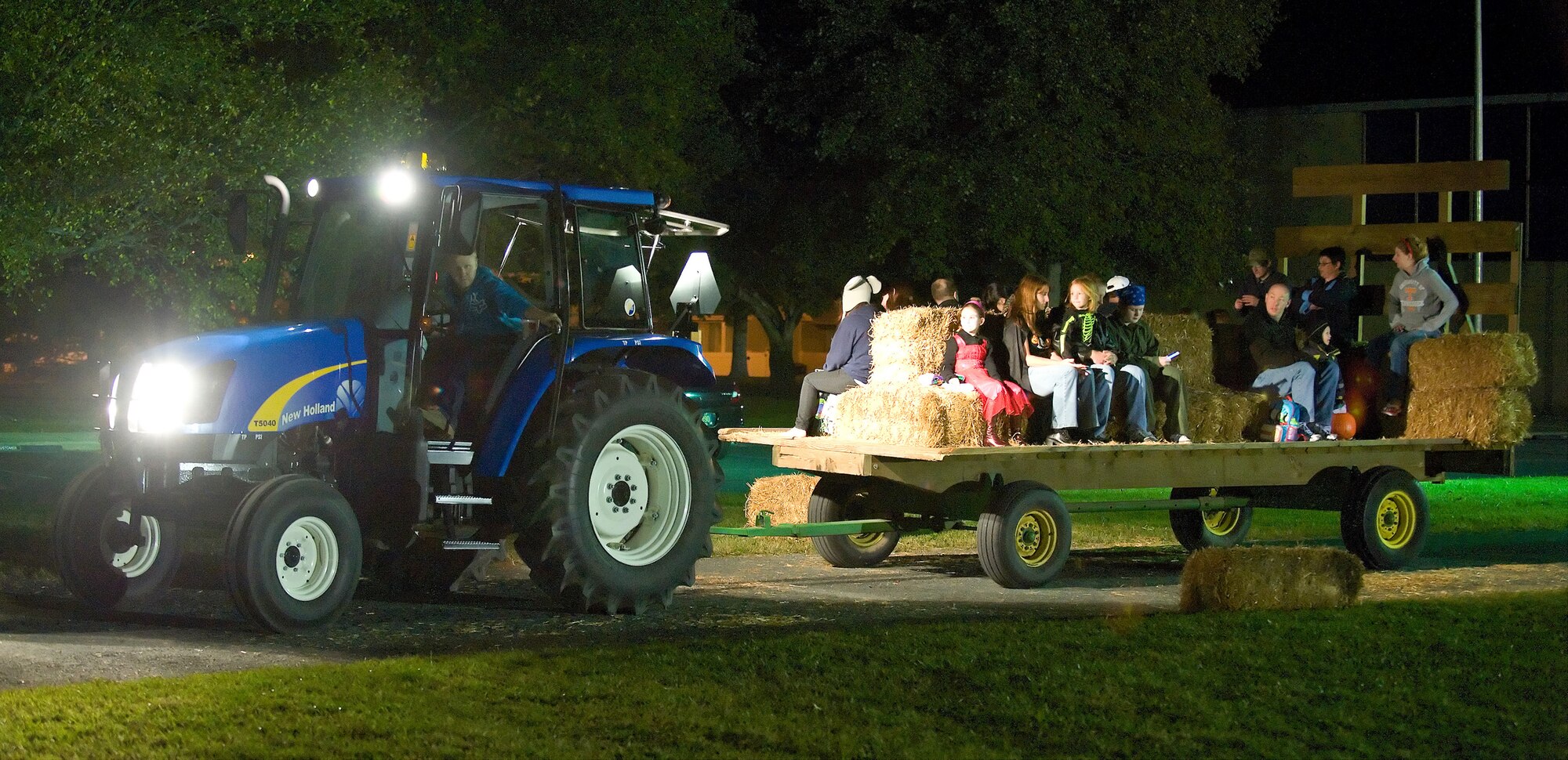 Attendees of the Harvest Festival and Trunk-R-Treat take part in a hay ride Oct. 30, 2010, at the Youth Center, Dover Air Force Base, Del. (U.S. Air Force photo by Roland Balik/Released)