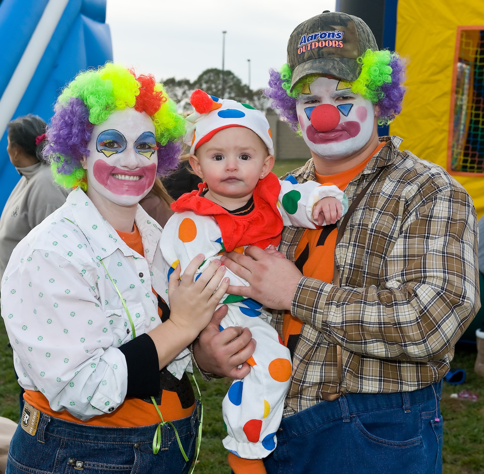Senior Airman Justin Corbett, 436th Logistics Readiness Squadron, his wife Aubrey, and daugther AvaJean, dressed up as clowns for the Harvest Festival and Trunk-R-Treat Oct. 30, 2010, at the Youth Center, Dover Air Force Base, Del.. (U.S. Air Force photo by Roland Balik/Released)