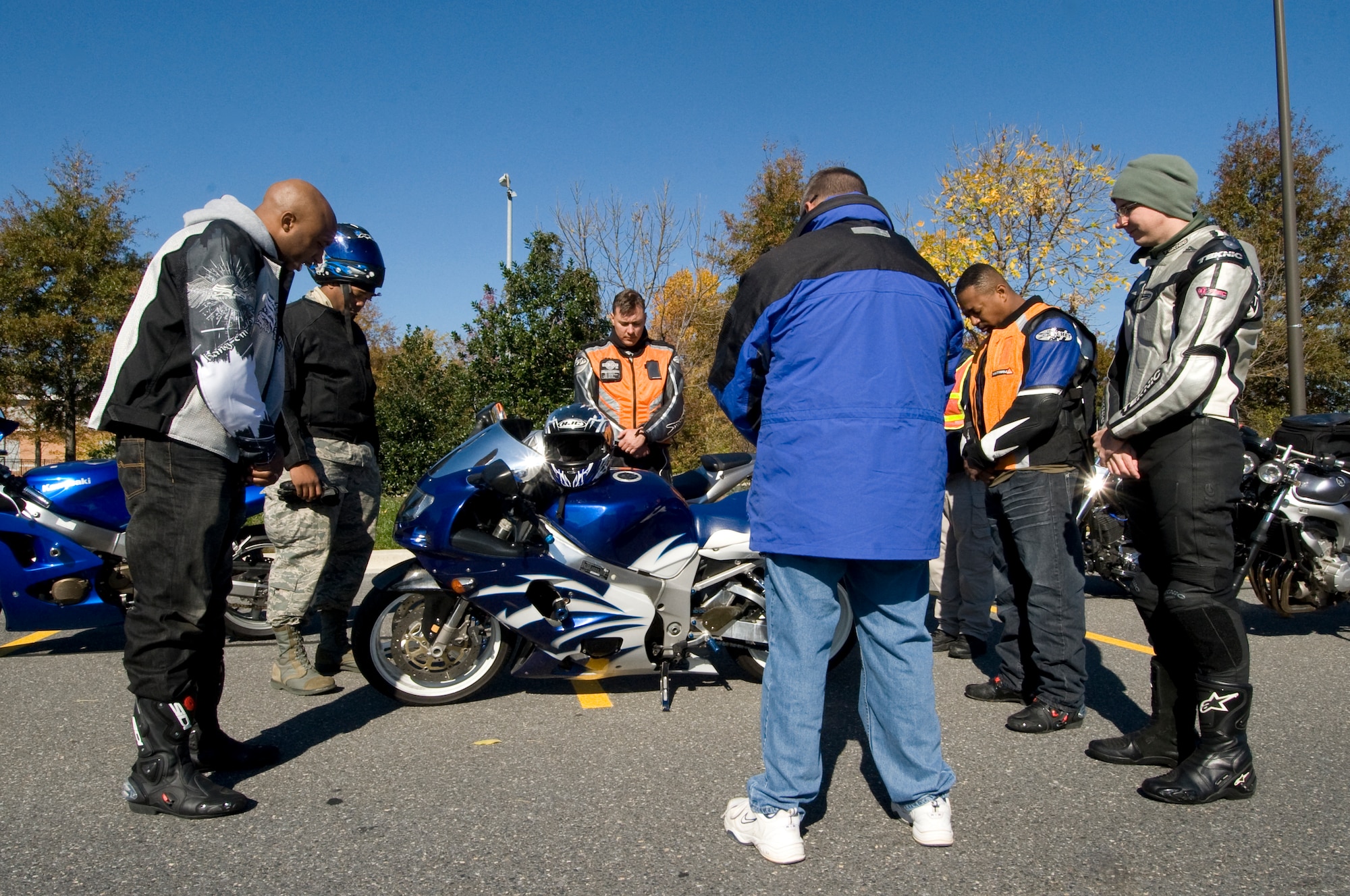 A collective group of concerned members from the 11th Wing say a prayer for the Airmen who lost their lives due to motorcycle accidents last year near an accident site in Bowie, Md., Nov. 1. There are plans to make the event an annual observance, and open it to all branches in order to bring awareness of safe motorcycle riding procedures. ( U.S. Air Force photo/ Bobby Jones)