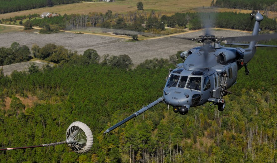 MOODY AIR FORCE BASE, Ga. -- An HH-60G Pave Hawk from the 41st Rescue Squadron conducts in-flight refueling during a combat search and rescue airpower demonstration here Oct. 29. The combat search and rescue demonstration simulates downed aircrew behind enemy lines and allows airmen to practice rescue-related missions.  (U.S. Air Force photo/Airman 1st Class Joshua Green)(RELEASED)
