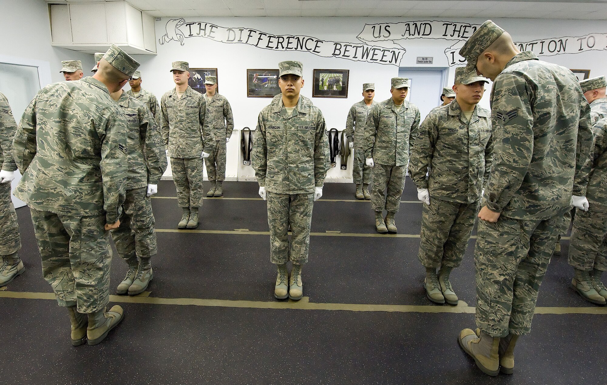 The Dover Air Force Base, Del., Honor Guard stands at attention as they are inspected by their trainers during morning formation Nov. 2, 2010. The honor guard performs daily inspections of dress and appearance and completes a set of push-ups for each uniform violation. (U.S. Air Force photo by Jason Minto/Released)