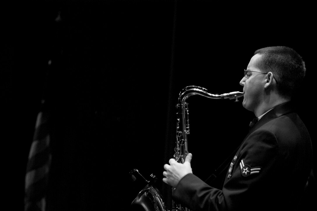 Airman First Class Greg Pflugh soloing on tenor saxphone with The Noteables jazz ensemble.