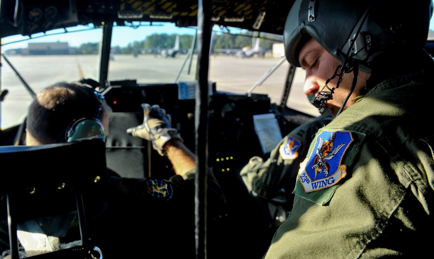MOODY AIR FORCE BASE, Ga. -- Tech Sgt. Larry Long, 71st Rescue Squadron flight engineer, straps in before take-off during an HC-130 Combat King flight here Oct. 29. Members from the 71st RQS were preparing for an HH-60G Pave Hawk in-flight refueling during the Flying Tigers Reunion. The reunion is an event inviting past Flying Tigers members to reunite at the 23rd Wing. (U.S. Air Force photo/Airman 1st Class Joshua Green)(RELEASED)
