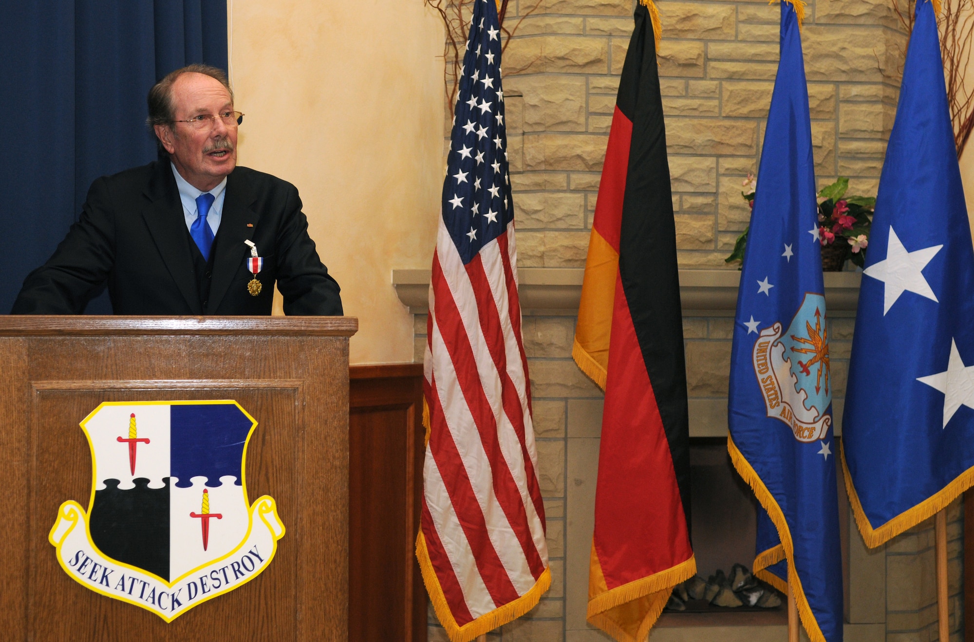 SPANGDAHLEM AIR BASE, Germany – Dr. Michael Dietzsch, host nation council chairman, speaks Nov. 2 after being awarded the U.S. Air Forces in Europe Medal of Distinction in recognition of outstanding support to the USAFE mission and community. Dr. Dietzsch has been working with the host nation council - an association that promotes German-American friendship in the Eifel - since its founding in 2003. (U.S. Air Force photo/Staff Sgt. Benjamin Wilson)