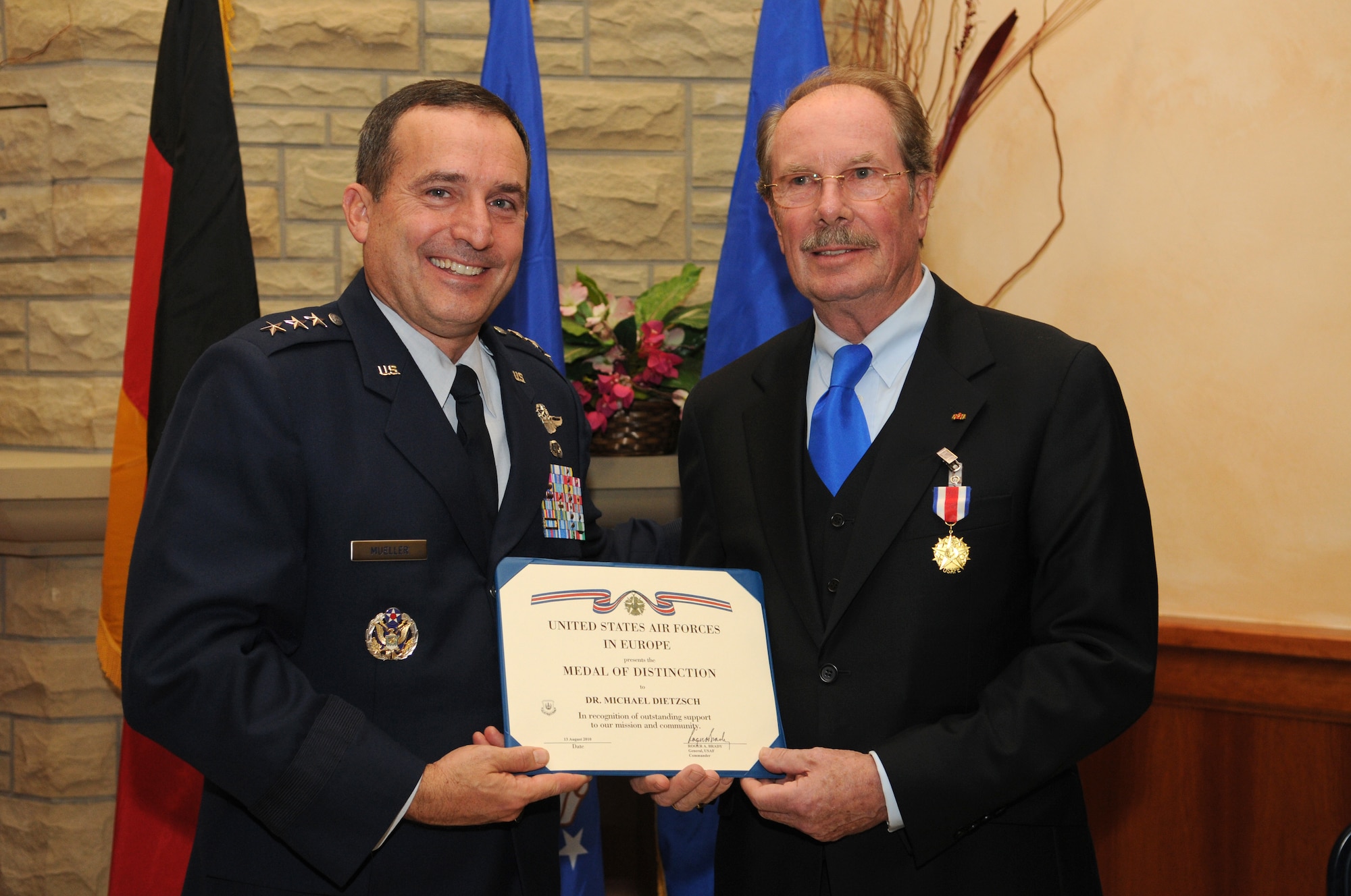 SPANGDAHLEM AIR BASE, Germany – Lt. Gen. Stephen Mueller, U.S. Air Forces in Europe vice commander, presents Dr. Michael Dietzsch, host nation council chairman, with the USAFE Medal of Distinction Nov. 2 in recognition of outstanding support to the USAFE mission and community. Dr. Dietzsch has been working with the host nation council - an association that promotes German-American friendship in the Eifel - since its founding in 2003. (U.S. Air Force photo/Staff Sgt. Benjamin Wilson)