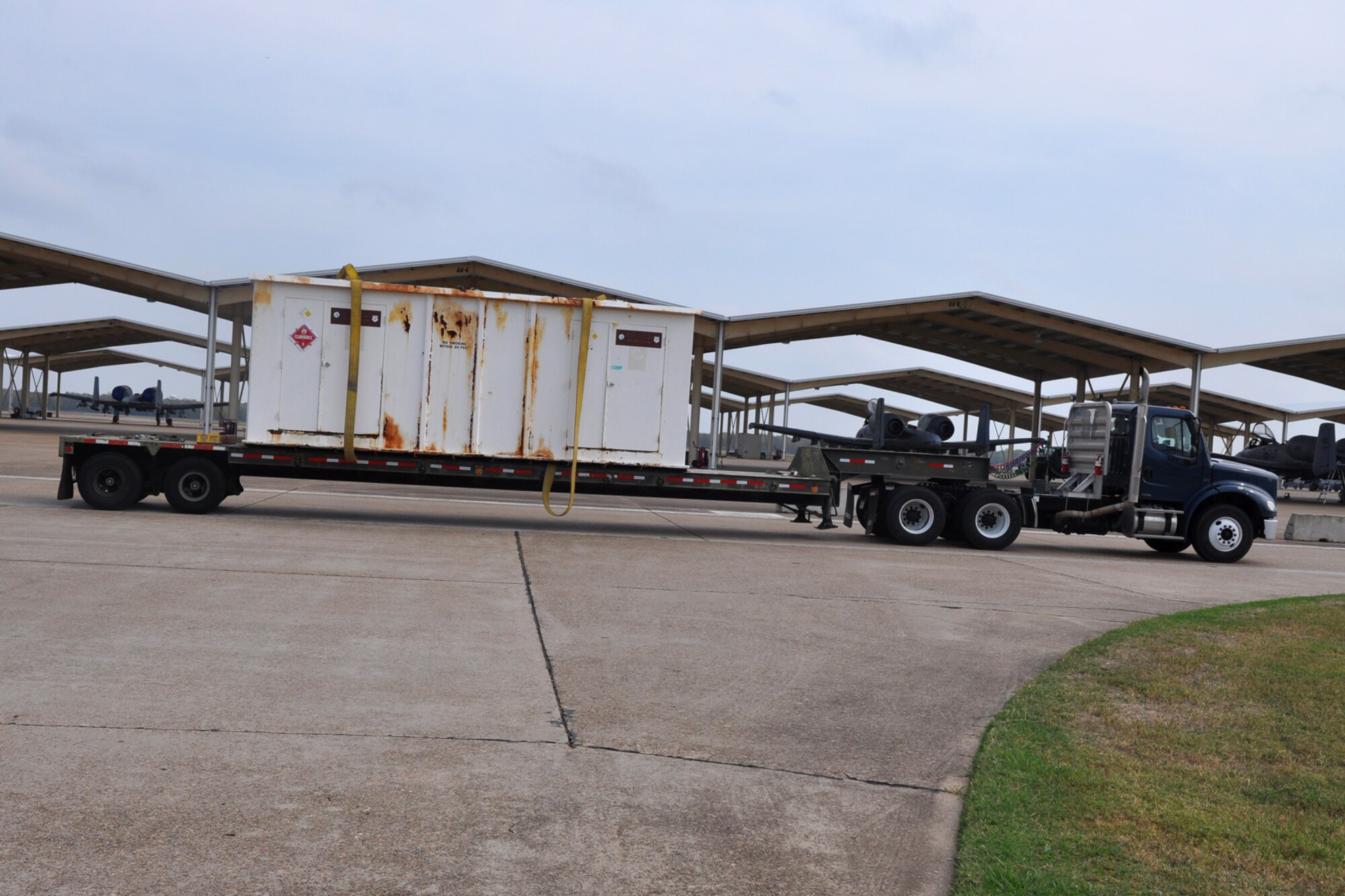 To allow room for construction, 18-wheeler carts off a storage container from the 917th Maintenance Squadron’s Metals Technology building on Barksdale Air Force Base, La., Oct. 22, 2010. Due to the every changing world of technology and advances in fabrication equipment, the 917th Wing is expanding the present structure by adding additional work space to the first floor and office spaces to the second floor. The shop deals with the fabrication of aircraft parts or air ground equipment for the 917th Wing. The addition of the advanced equipment will give greater capabilities to the shop to accomplish their mission. (U.S. Air Force photo/Betty Stephens)  