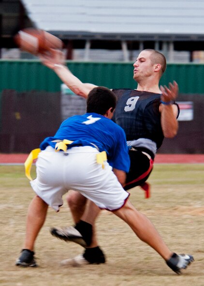 Chase Whited, quarterback for the 96th Security Forces Squadron, releases the throw as his flag is pulled by a 53rd Wing defender during an intramural playoff game Nov. 2 at Eglin Air Force Base, Fla.   The 53rd won the game 19-13 to advance in the tournament.  The championship game is Nov. 9 at 5 p.m.  (U.S. Air Force photo/Samuel King Jr.)