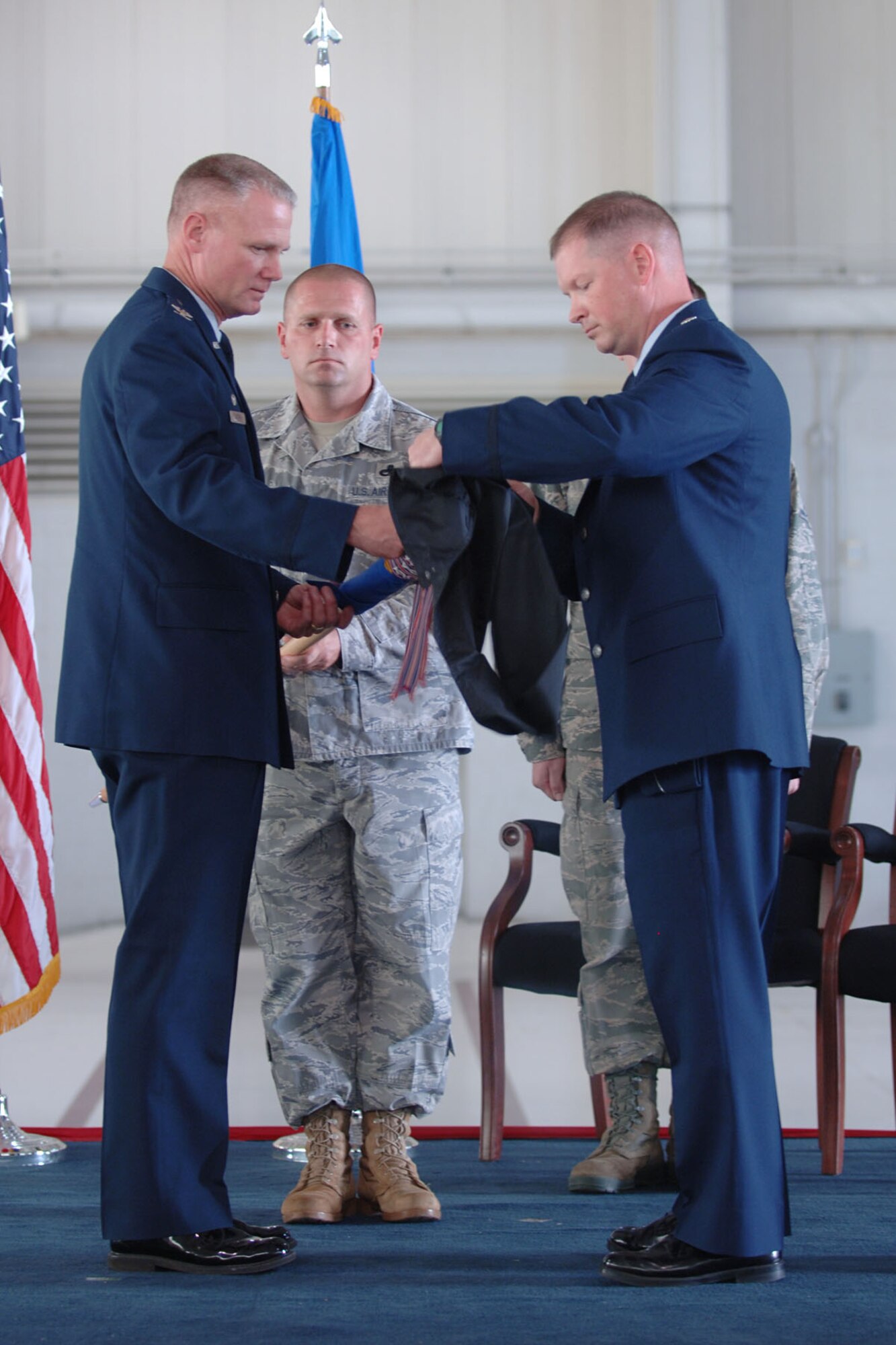 LANGLEY AIR FORCE BASE, Va. -- Col. George Zaniewski (left), 1st Maintenance Group commander, and Lt. Col. Jason Gibson, former 1st Equipment Maintenance Squadron commander, case the guidon of the 1 EMS during the 1st Component Maintenance Squadron inactivation and 1 EMS re-designation ceremony at the 149th Fighter Squadron Hangar Oct. 29. The 1 EMS was re-designated as the 1st Maintenance Squadron, absorbing the 1 CMS’ personnel upon its inactivation. (U.S. Air Force photo/Airman 1st Class Jason J. Brown) (RELEASED)