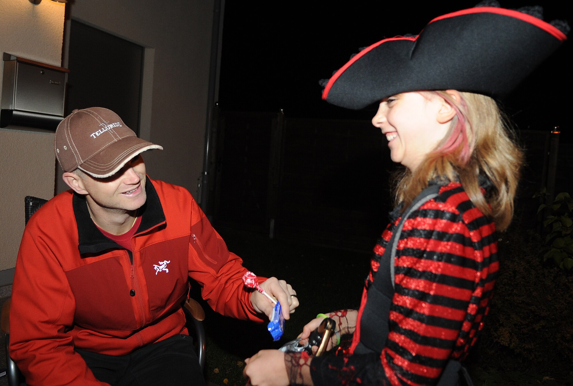 SPANGDAHLEM AIR BASE, Germany – Col. Chris Weggeman, 52nd Fighter Wing commander, gives candy to Amber Mein, 10, during trick-or-treating at base housing Oct. 31. Both German and American children were invited to the event giving base members an opportunity to share an American tradition with the local-national community. (U.S. Air Force photo/Senior Airman Nick Wilson)