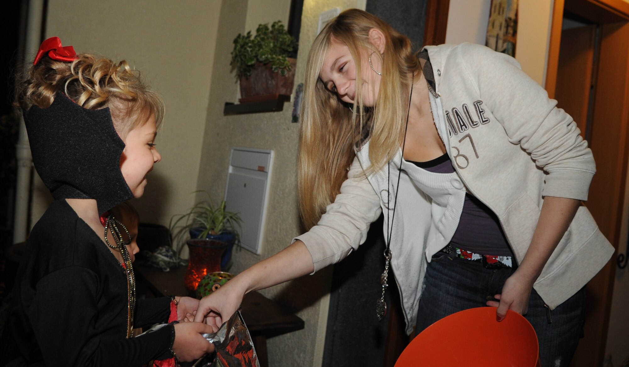 SPANGDAHLEM AIR BASE, Germany –Col. Matthew Flood’s, 52nd Munitions Maintenance Group commander, daughter Piper Flood gives Halloween candy to Landyn Clark, 5, during trick-or-treating at base housing Oct. 31. Both German and American children were invited to the event giving base members an opportunity to share an American tradition with the local-national community. (U.S. Air Force photo/Senior Airman Nick Wilson)