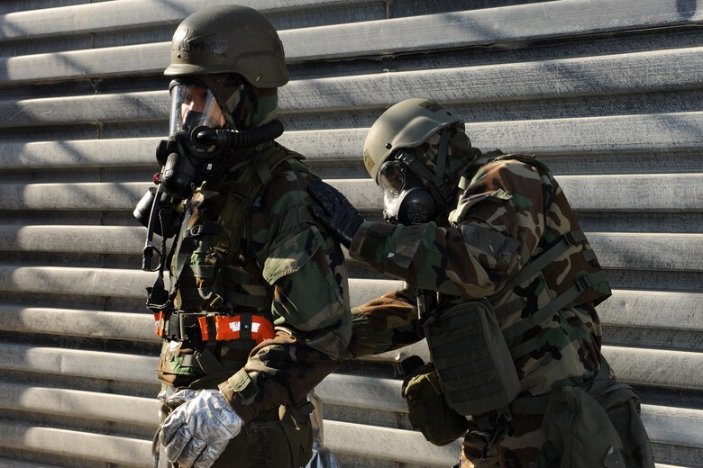 KUNSAN AIR BASE, Republic of Korea -- Chief Master Sgt. James Sanders, 8th Fighter Wing command chief, performs a buddy check on another Wolf Pack member Nov. 3 to ensure proper wear of chemical gear during exercise Beverly Midnight 10-05. Proper wear of all issued chemical and individual protection equipment gear issued is vital to mission success whether during an exercise or in a deployed location. (U.S. Air Force photo/Staff Sgt. Jonathan Pomeroy)