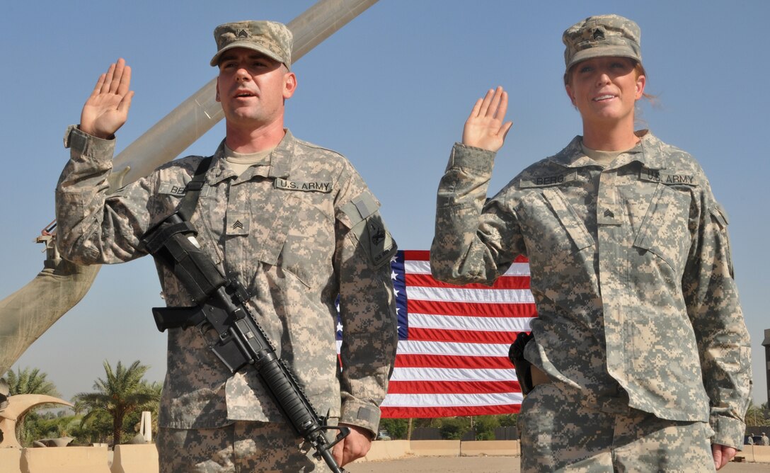 Army Sgt. Matthew Berg and his wife, Army Sgt. Ashleigh Berg, re-enlist Oct. 21, 2010, in Baghdad. U.S. Army photo by Staff Sgt. Brandon Moreno


