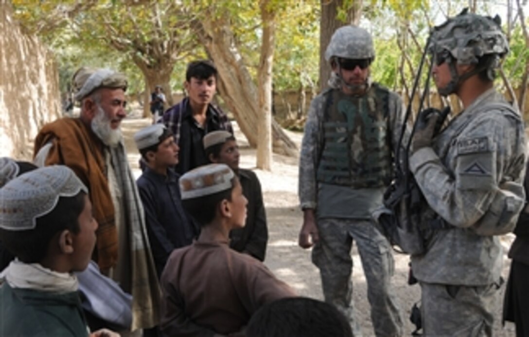 A U.S. Army soldier from Charlie Company, 1st Battalion, 4th Infantry Regiment speaks with a village elder during a patrol in the Zabul province of Afghanistan on Oct. 25, 2010.  