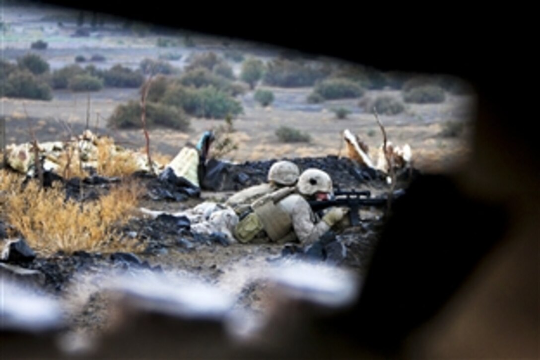 A U.S. Marine uses the scope on his weapon to scan the area while providing security during Operation Steel Dawn II, a clearing operation in Barham Chah, Helmand province, Afghanistan, Oct. 30, 2010. The Marines are assigned to the 4th Light Armored Reconnaissance Battalion.