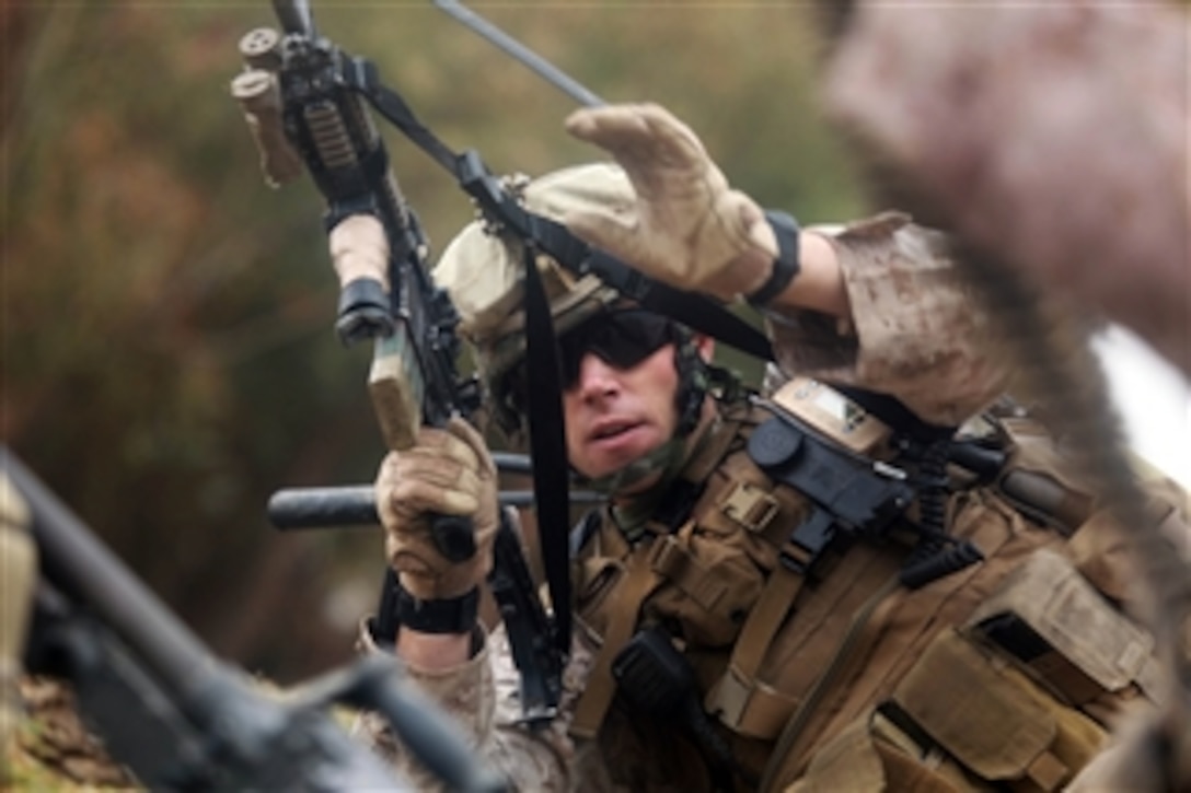 U.S. Marine Corps Sgt. Michael Gilio, with India Company, 3rd Battalion, 5th Marine Regiment, Regimental Combat Team 2, prepares to return fire during an engagement with enemy fighters during a security patrol in Sangin, Afghanistan, on Oct. 29, 2010.  Marines conducted security patrols to decrease insurgent activity and gain the trust of the Afghan civilians.  The battalion was one of the combat elements of Regimental Combat Team 2, whose mission was to conduct counterinsurgency operations with the International Security Assistance Force.  