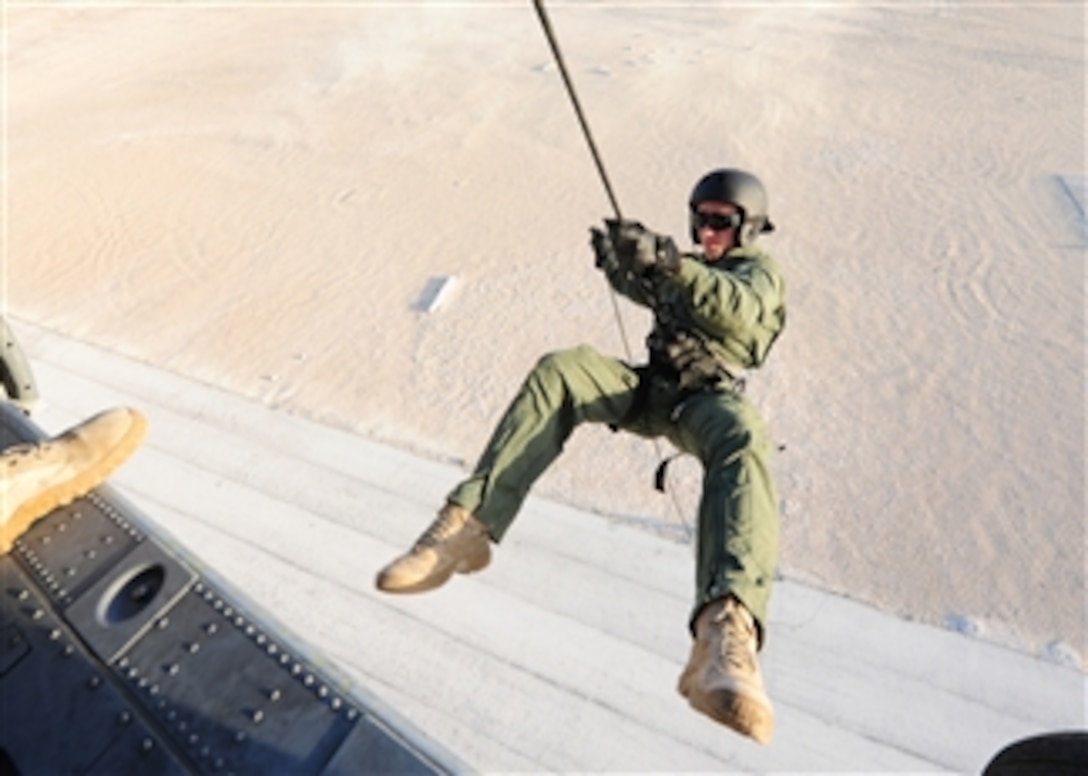 U.S. Navy Petty Officer 2nd Class Michael Reedy, assigned to Mobile Diving and Salvage Unit 2 rappels from an SH-60 Seahawk helicopter during a joint training event between U.S. and U.K. sailors in Manama, Bahrain, on Oct. 20, 2010.  Mobile Diving and Salvage Unit 2 supports maritime security operations in the U.S. 5th Fleet area of responsibility.  