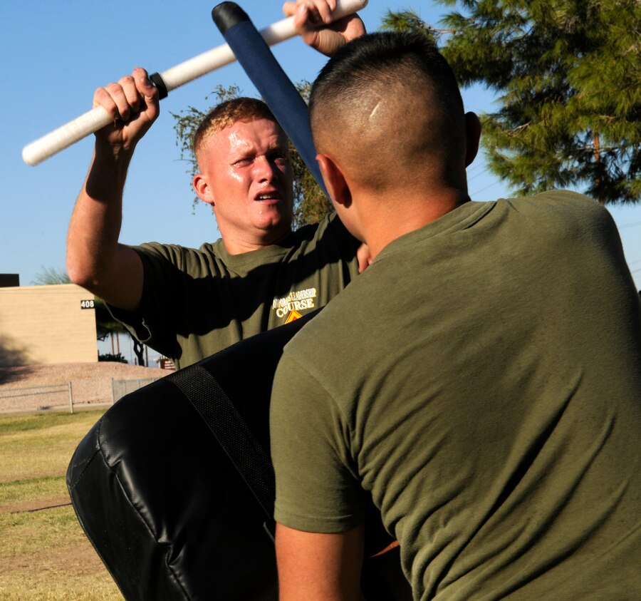 Cpl. Steven Simon, Headquarters and Headquarters Squadron information technology technician, defends himself from a baton attack after being sprayed with OC, a form of pepper spray, Nov. 3, 2010. Approximately 20 Marines qualified to carry OC spray as part of their training for the station’s crisis management force, which augments military police here. “It teaches them through hands-on experience how (the enemy) can still fight through the pain of being sprayed,” said Staff Sgt. Jeffery Worley, military policeman.