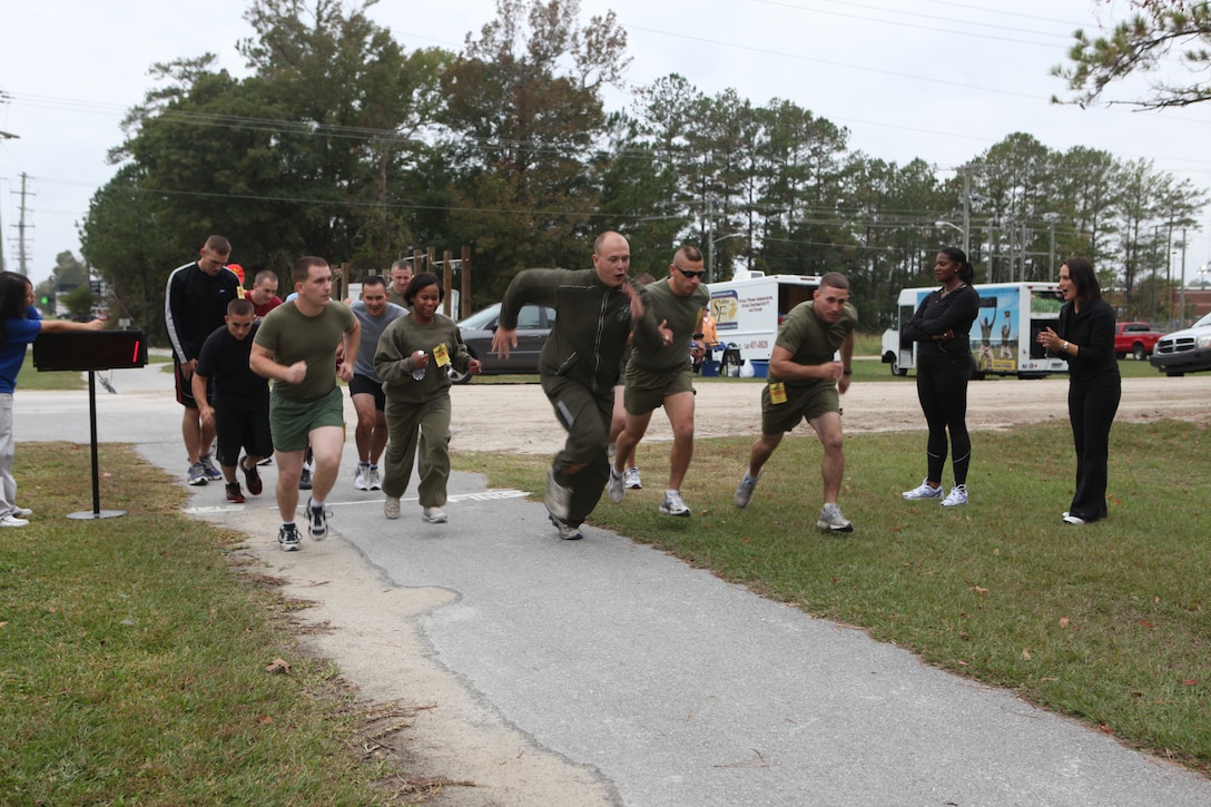 Active-duty service members, Department of Defense employees and retired Marines cross the starting line during the Marine Corps Community Services’ 5K Liberty Run aboard Marine Corps Base Camp Lejeune, Nov. 4.  The run was held in honor of the Marine Corps birthday and Veterans Day, which are celebrated Nov. 10 and Nov. 11, respectively.