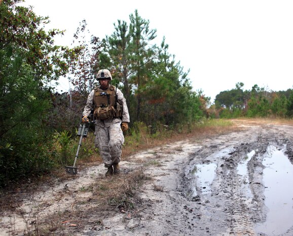Staff Sgt. Dominic Chavez, an explosive ordnance technician with EOD Company, 8th Engineer Support Battalion, 2nd Marine Logistics Group, sweeps a road with a metal detector during Improvised Explosive Device Response training at Camp Dave South Training Ground, one of the many training areas aboard Camp Lejeune, N.C., Nov. 4, 2010. During the training, EOD technicians were given the opportunity to brush up on their skills and find simulated IEDs scattered throughout the training grounds by fellow technicians. (U.S. Marine Corps photo by Pfc. Franklin E. Mercado)