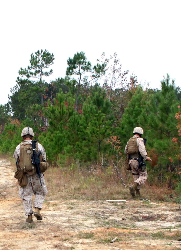 Two explosive ordnance disposal technicians with EOD Company, 8th Engineer Support Battalion, 2nd Marine Logistics Group, respond to a call received about a simulated improvised explosive during IED Response training at Camp Dave South Training Ground, one of the many training areas aboard Camp Lejeune, N.C., Nov. 4, 2010. During the training, EOD technicians were given the opportunity to brush up on their skills and find simulated IEDs scattered throughout the training grounds by fellow technicians. (U.S. Marine Corps photo by Pfc. Franklin E. Mercado)