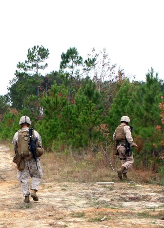 Two explosive ordnance disposal technicians with EOD Company, 8th Engineer Support Battalion, 2nd Marine Logistics Group, respond to a call received about a simulated improvised explosive during IED Response training at Camp Dave South Training Ground, one of the many training areas aboard Camp Lejeune, N.C., Nov. 4, 2010. During the training, EOD technicians were given the opportunity to brush up on their skills and find simulated IEDs scattered throughout the training grounds by fellow technicians. (U.S. Marine Corps photo by Pfc. Franklin E. Mercado)