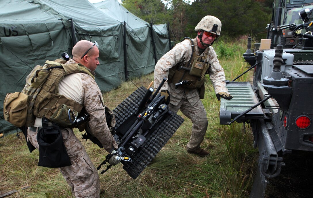Two explosive ordnance disposal technicians with EOD Company, 8th Engineer Support Battalion, 2nd Marine Logistics Group, load a MK II Talon Robot onto a humvee during Improvised Explosive Device Response training at Camp Dave South Training Ground, one of the many training areas aboard Camp Lejeune, N.C., Nov. 4, 2010. During the training, EOD technicians were given the opportunity to brush up on their skills and find simulated IEDs scattered throughout the training grounds by fellow technicians. (U.S. Marine Corps photo by Pfc. Franklin E. Mercado)